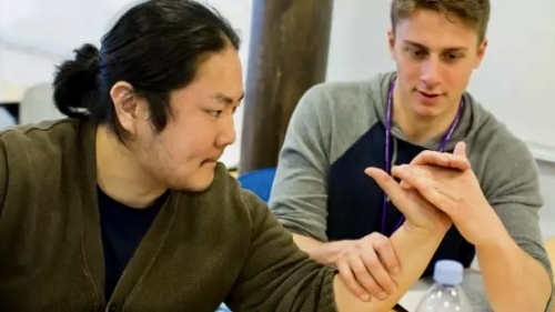 Student helping patient with occupational therapy