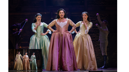 Three singers on stage in tour of Hamilton
