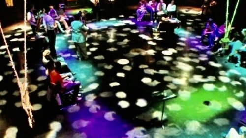 Darkened audio studio with lots of colorful spotlights