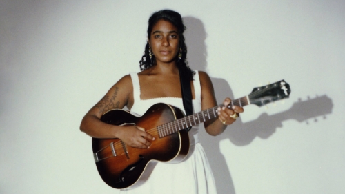 Leyla McCalla holds a guitar