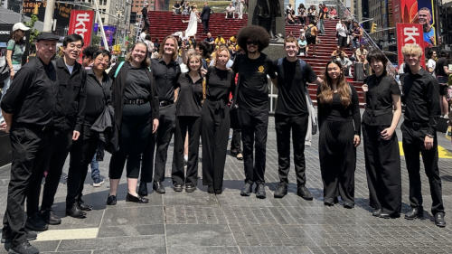 Percussion summer students all dressed in black posing in Times Square for a photo