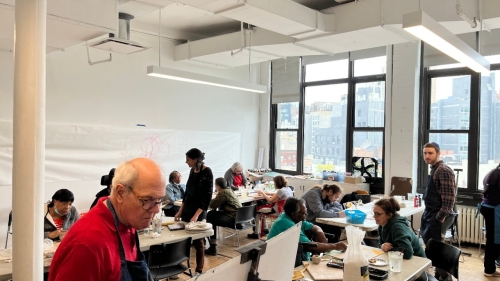 People work on projects in a studio.