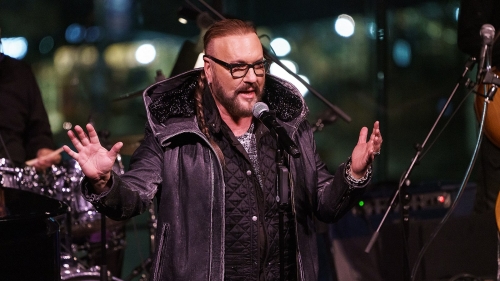 Desmond Child in front of a band