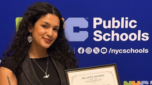 Gabriela holds her 2025 Big Apple Award certificate