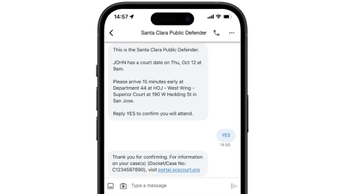 A phone displays a sample text message reminder. The Public Defender texts John about his upcoming court date, time, and location, which John confirms by replying "YES." The auto-reply from the Public Defender offers the case number and a web link for additional information..