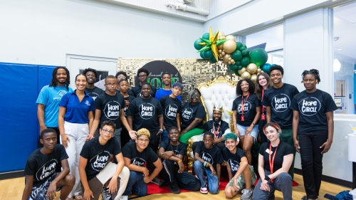 A group of people in HOPE Circle t-shirts poses for the photo