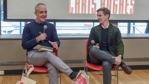 Nelms and Hughes sit and talk in front of a screen showing the Marketcrafters book cover
