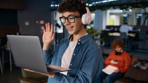Smiling teenage boy having a work video call