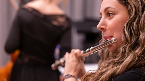 Close up of flautist warming up for performance