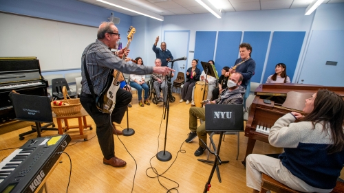 Alan Turry leading a class of students playing instruments and having fun