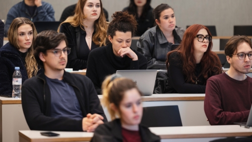 Students in class listening to professor teach