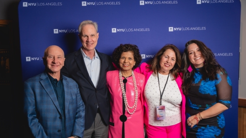 Larry Miller, Jack Knott, Chandrika Tandon, , Nina Sadowsky, and Nicole Zuraitis pose for the photo in front of an NYU logo backdrop