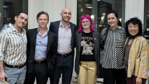 Six panel speakers standing together for a photo.