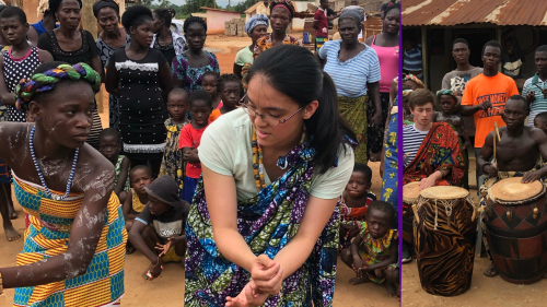West African girl teaching student dance while group gathers to watch