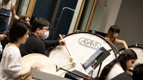 Students play percussion instruments