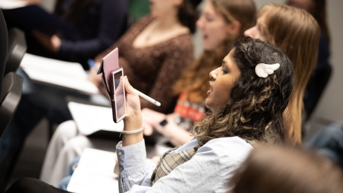 A student reads the script from her phone.