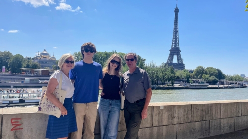 Susan Jurevics with her family, photographed in front of the Eiffel Tower