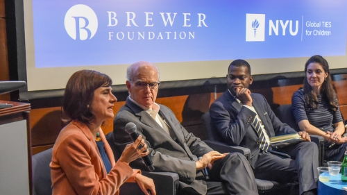 Four panelists sit together talking