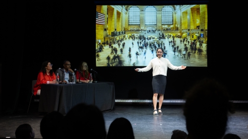 Kadam presents in front of a screen showing Grand Central Station.