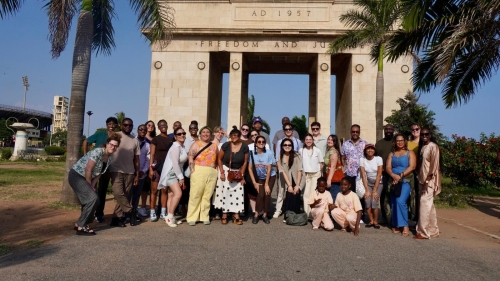 group standing in front of monument 