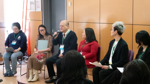 Panelists sit and talk.