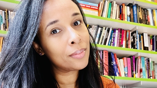 Dr. Honey Crawford sits in front of a bookshelf 