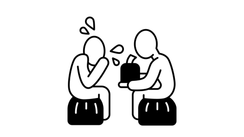 Two people sitting across from one another, one crying and the other offering tissues.