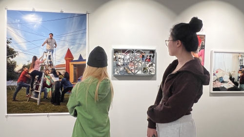 VAA students look at artwork on display for the Global Arts Ecosystem course.