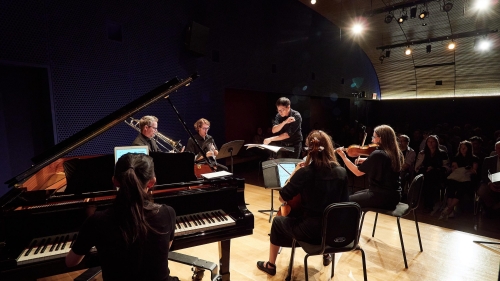 Photo of the Mise-En Ensemble performing in a small theatre