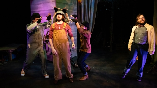 Four students on stage performing in The Handless Maiden