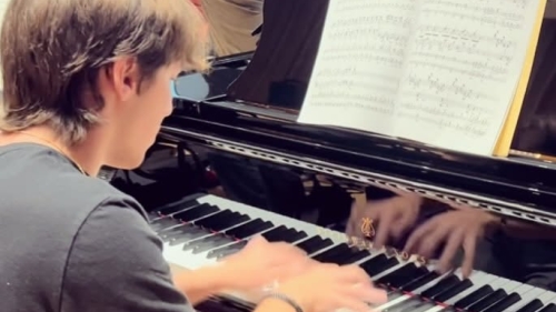 Student at the keyboard of grand piano