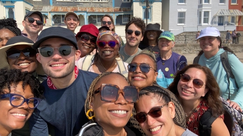 A group of smiling teachers poses for a photo in Weymouth, UK