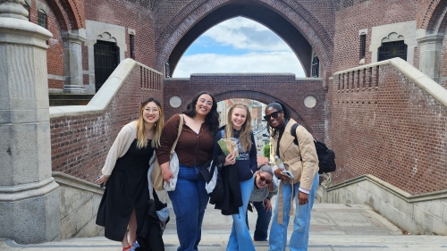 Four smiling students pose in front of Helsingborg Castle