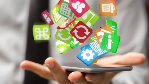 A collection of apps float above a smartphone screen in someone's hand. 