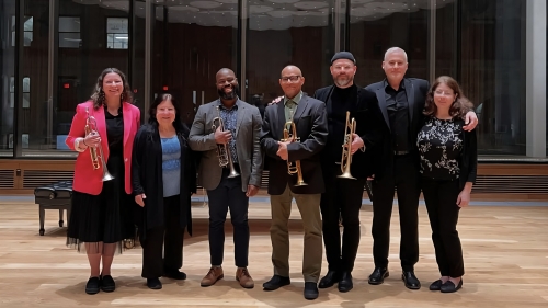 Eight NYU Brass studies faculty lined up for group pic