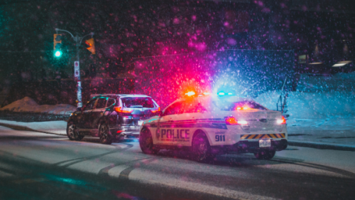 Police Car and a SUV parked on Roadside