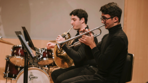 Two brass students practicing instruments