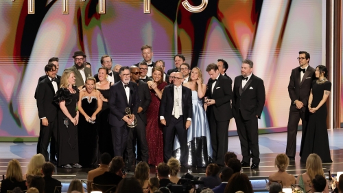 People gather around an onstage microphone