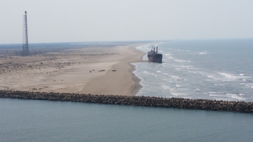 A cargo ship is seen making ground on a beach