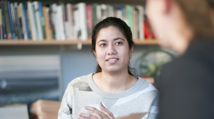 A graduate student in a meeting