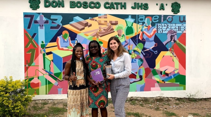 Students stand with an educator infront of Don Basco School, Accra, Ghana. 