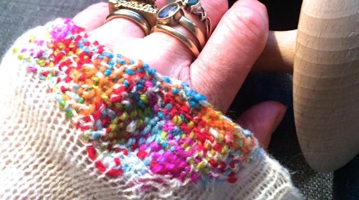 Kate Sekules mending, hand in sweater