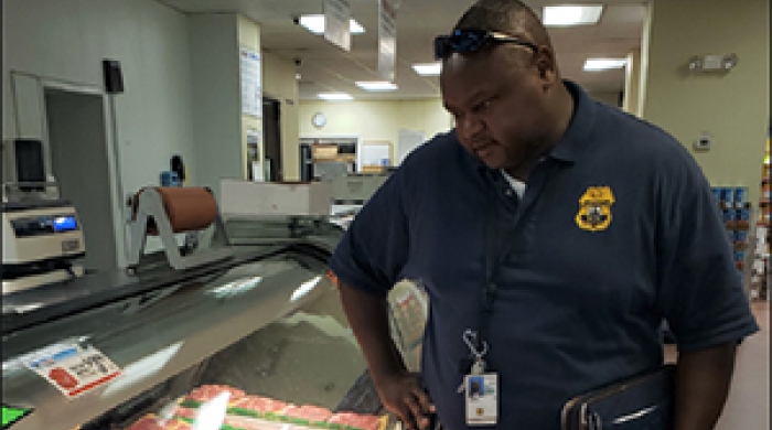 Joseph Ndungu inspecting packages of meat.