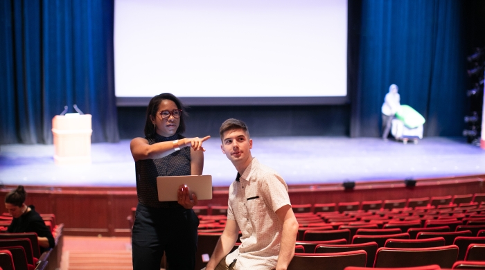 Students in the Skirball Theater with a laptop