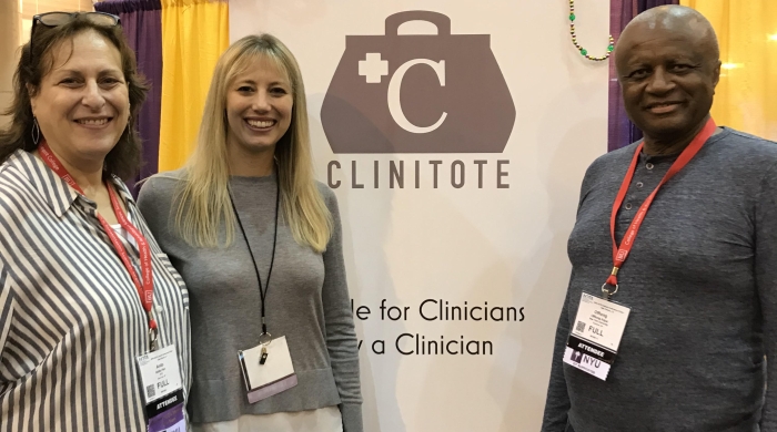 Department of Occupational Therapy alum Cami Culwell with Clinical Associate Professors Anita Perr and Offiong Aqua in front of a sign for Clinitote at the 2019 AOTA conference.