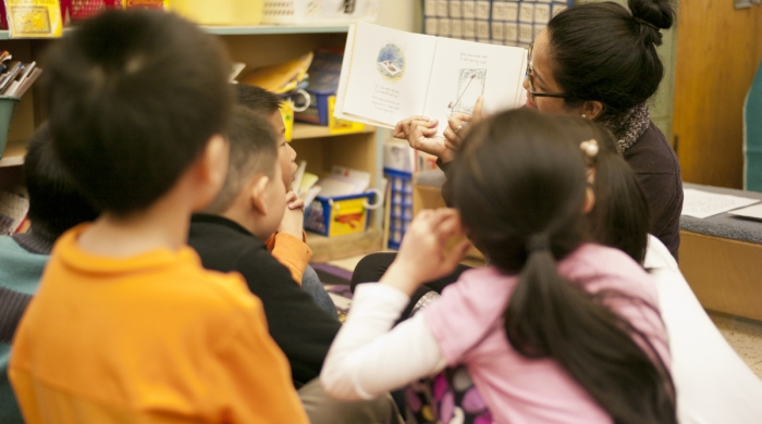 stock image of teachers reading to a student