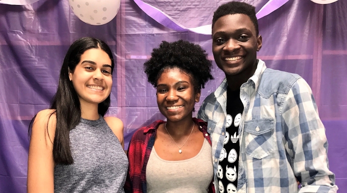 Three people posing and smiling