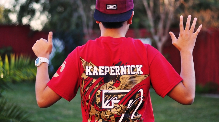 A boy wearing a Kaepernick-printed shirt