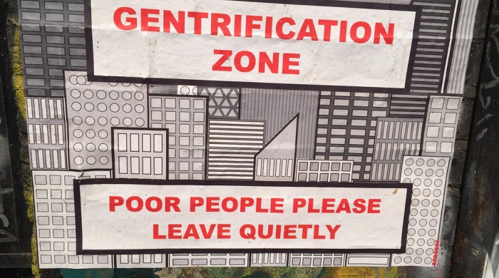 Street art with text "gentrification zone" and "poor people please leave quitely"