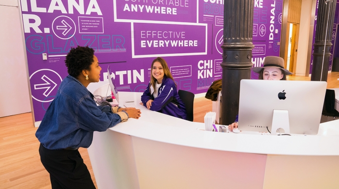 Students chatting at the front desk at the Welcome Center